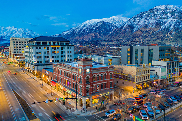 Evening photo of downtown Provo City with snowcapped mountains in the background